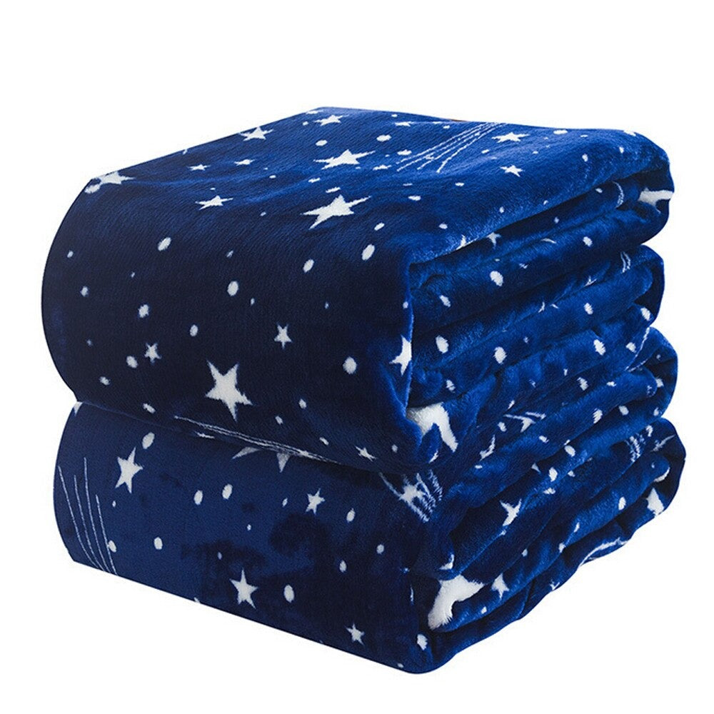 Two dark blue fleece blankets folded up and on top of each other. The blankets have stars printed on them.