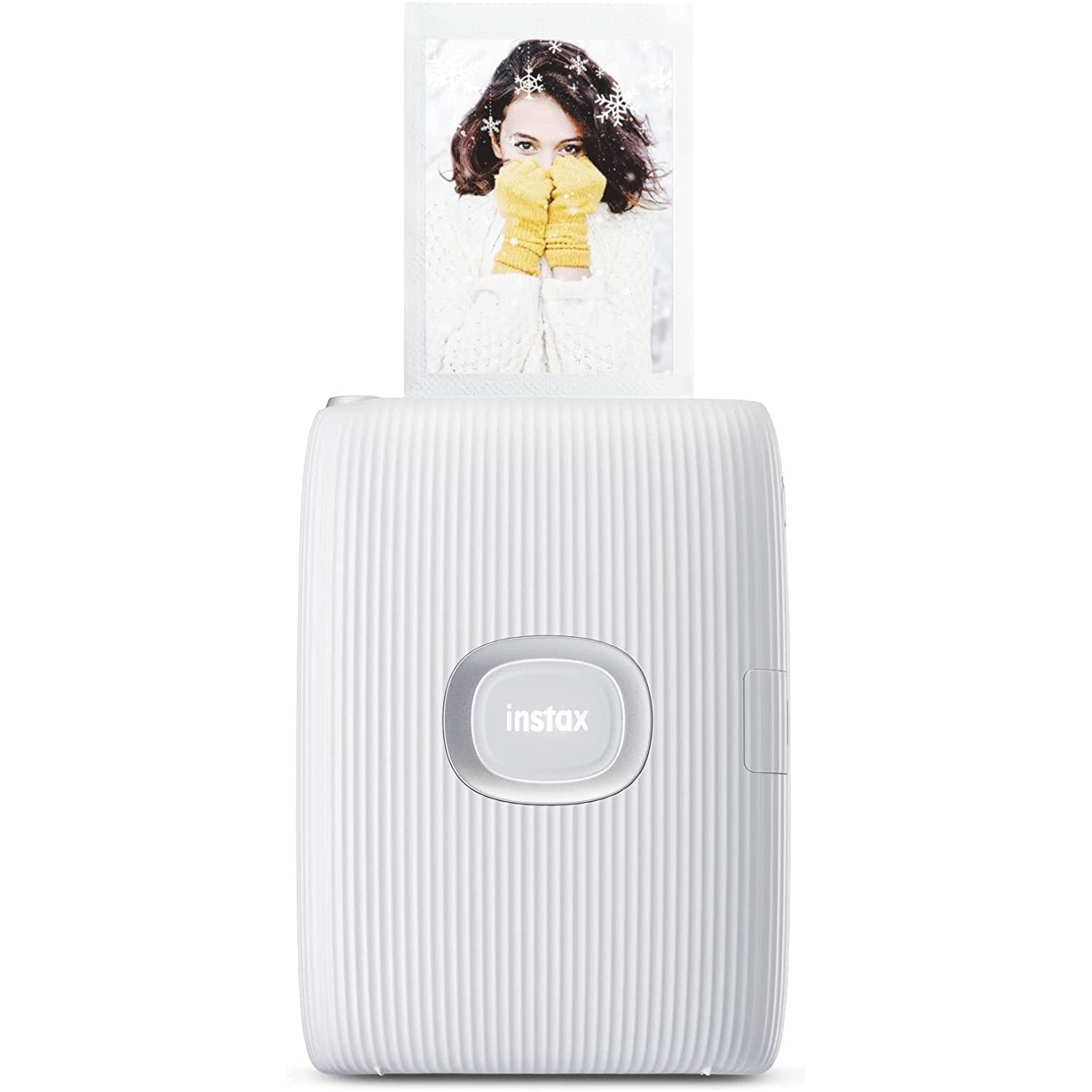 A white smartphone printer with an 'Instax' logo. There is a photo of a woman in the snow being printed from the machine.