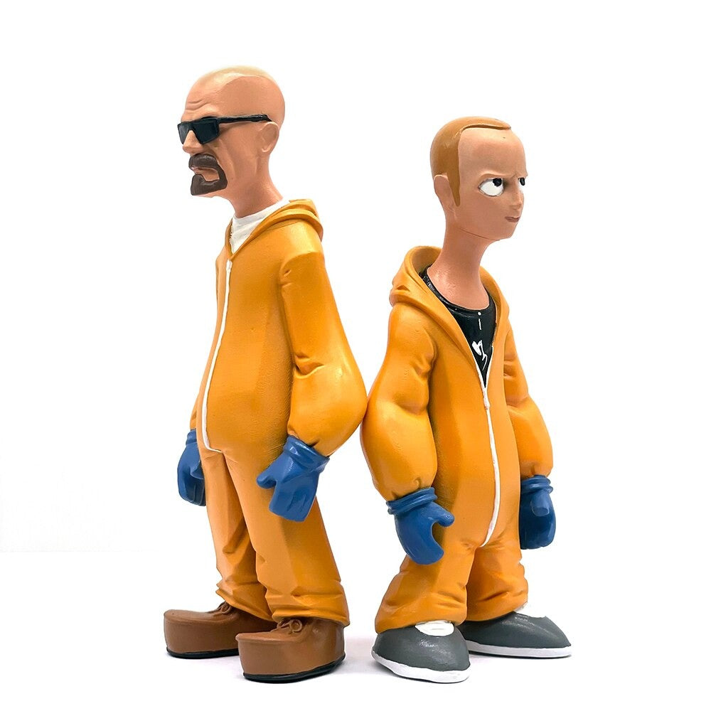 Figurines of Walter and Jesse from the TV show Breaking Bad. The figurines are at a 45 degree angle to each other. They are wearing orange hazmat suits and blue gloves.