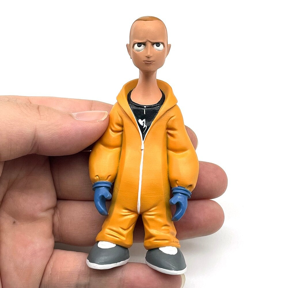 A plastic figurine of Jesse Pinkman from the TV show Breaking Bad. He is wearing his trademark hazmat suit and sneakers. The figurine is in the palm of a hand to show the approximate size.