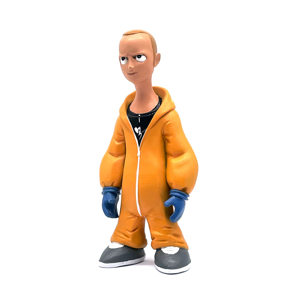 A figurine of Jesse Pinkman from the TV show Breaking Bad. He is wearing an orange hazmat suit, blue protective gloves and sneakers. He is on a white background at a 45 degree angle.