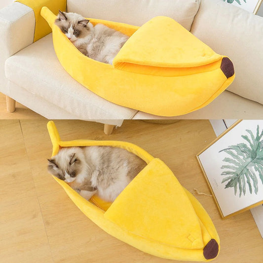 Two ragdoll cats sleeping in yellow banana shaped cat beds.