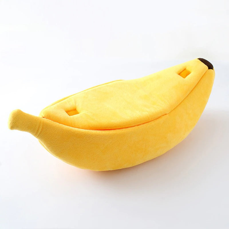 A banana shaped cat bed on a white background. 