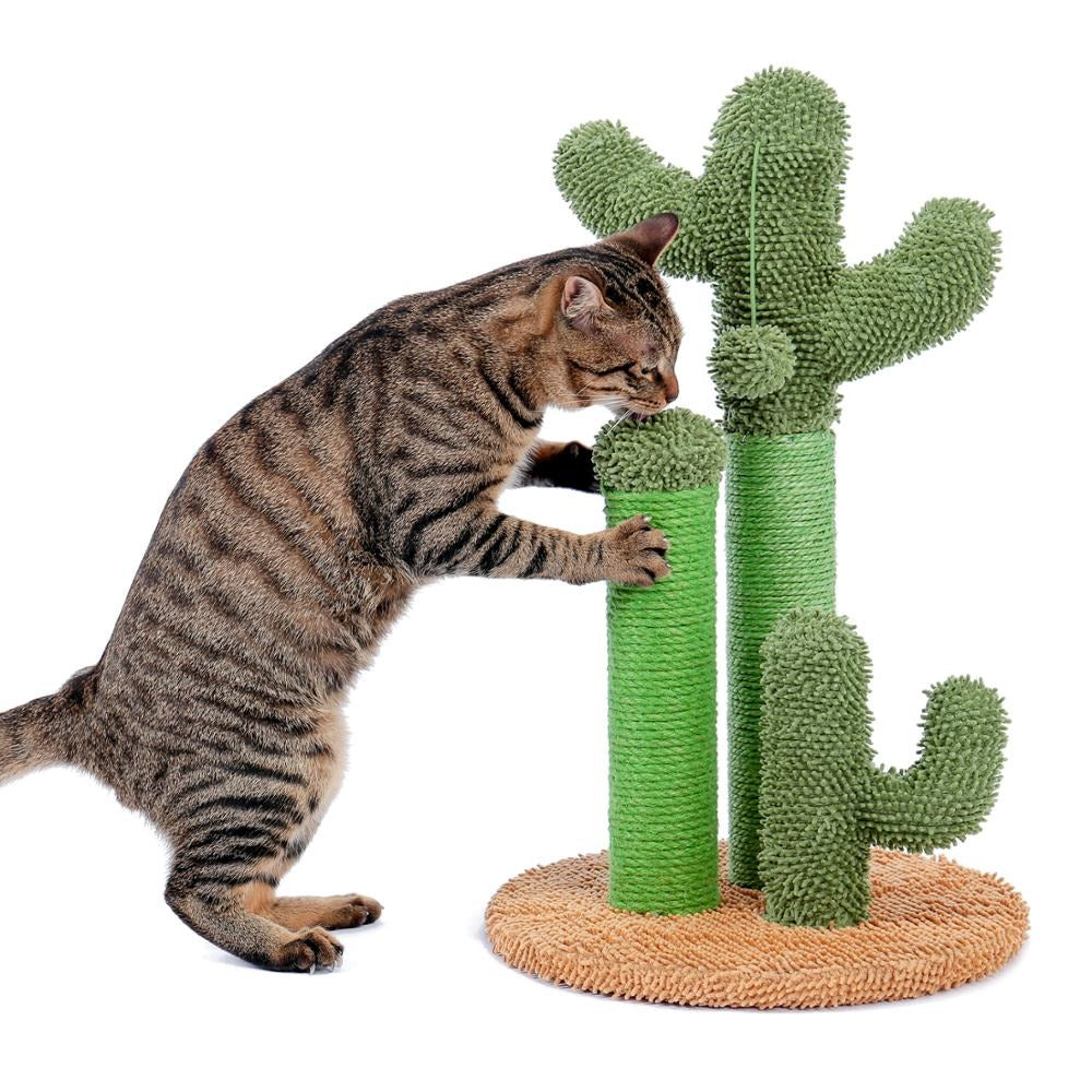 A cat with stripes is investigating a cat scratching post shaped like a green cactus.