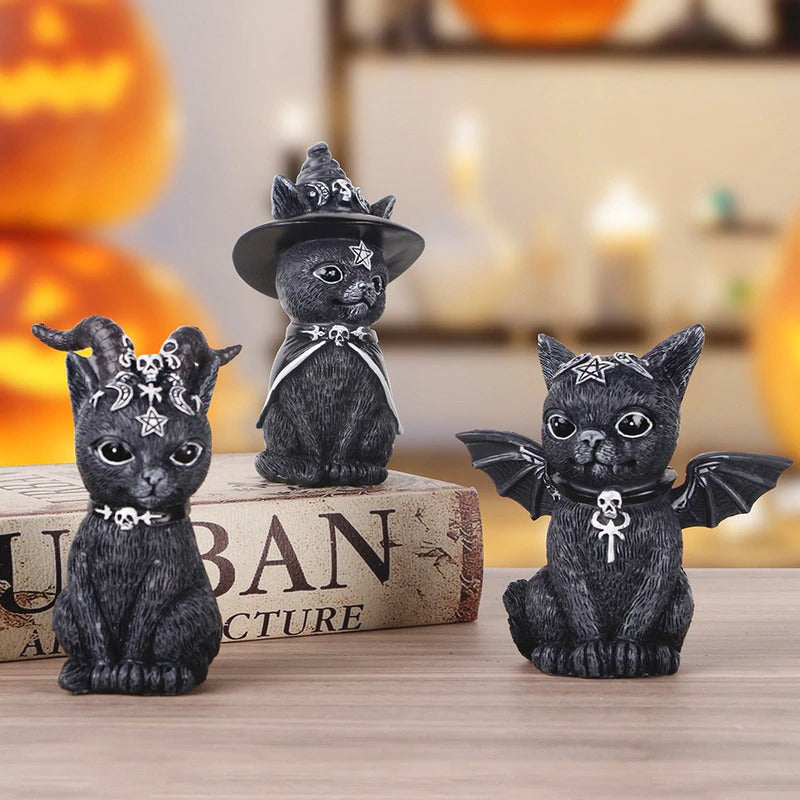 Three black cat wizard figurines complete with hats, horns and wings.