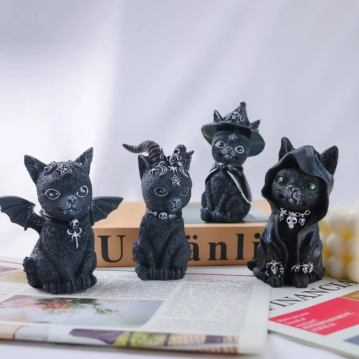 Four clack cat figurines dressed up as wizards
