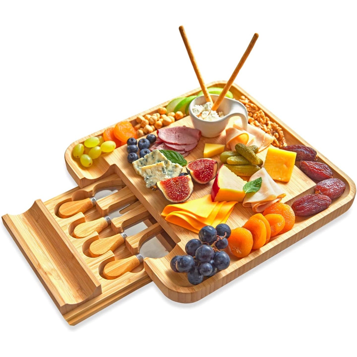 A bamboo cheese board and knife set with slide-out cutlery drawer filled with various cheese and nibbles. 
