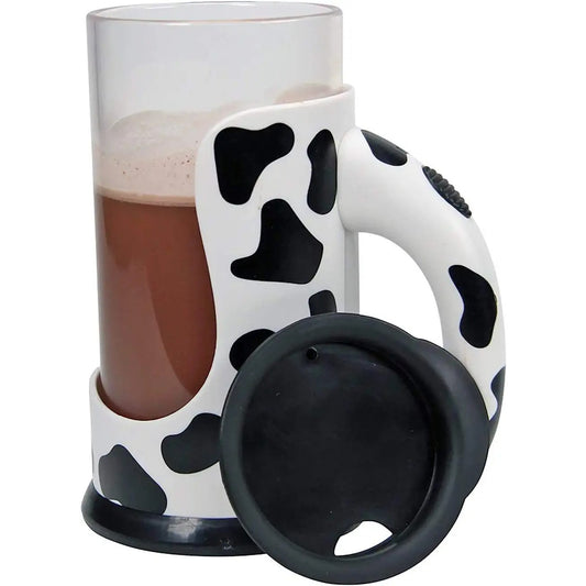 A chocolate milk mixing cup with a cow pattern and chocolate milk in the cup.