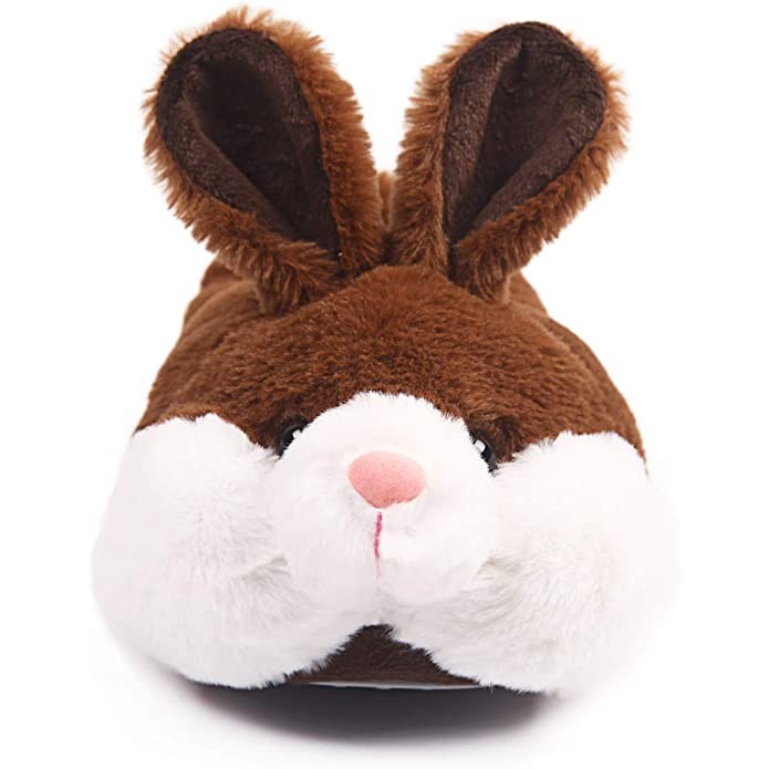 A close-up of the face on a brown and white bunny slipper.