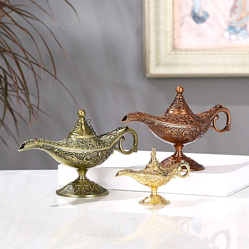 Three classic magic genie lamps colored gold, copper and antique brass.