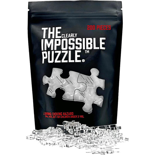 Packaging for The Clearly Impossible Puzzle which is a jigsaw puzzle made up of clear pieces. There are some example clear pieces laying in front of the packet.