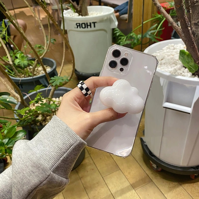 A phone case grip holder which has a white cloud on the back as the grip holder itself.
