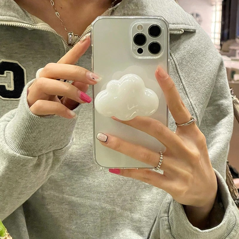 A phone grip holder and the grip is in the shape of a cloud which is attached to the back of the phone case.
