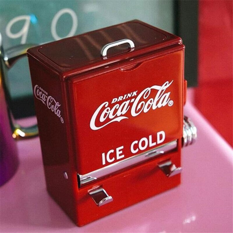 A retro old school style red and white Coca Cola toothpick dispenser which looks like a mini Coca Cola fridge.