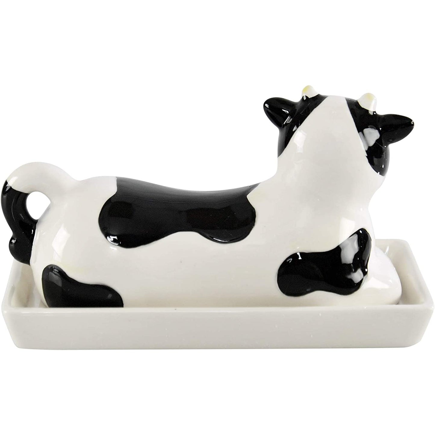 The back of a black and white cow shaped butter dish.
