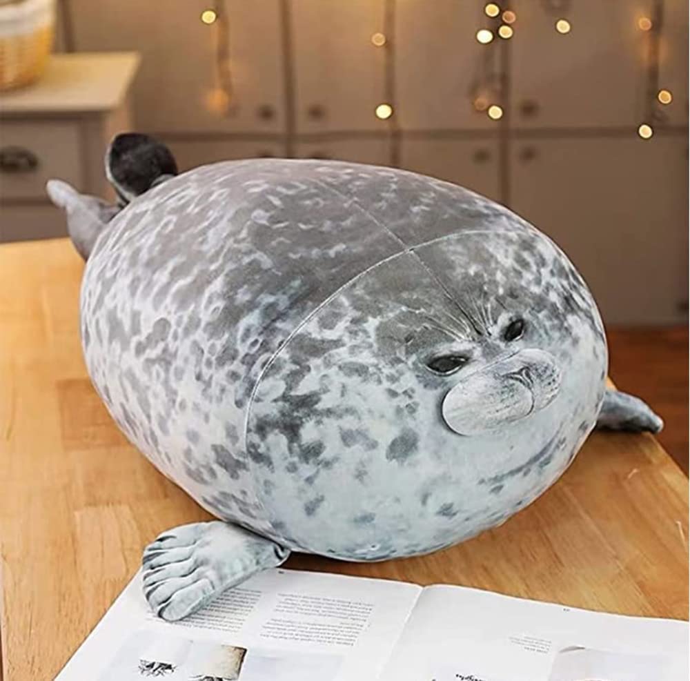 A pillow shaped as a seal on a wooden table