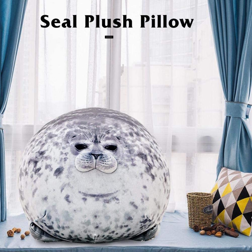 Seal plush pillow in front of a window