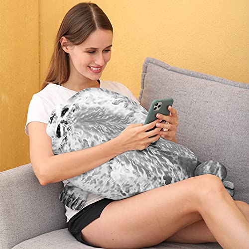 Woman on a grey lounge cuddling a seal pillow