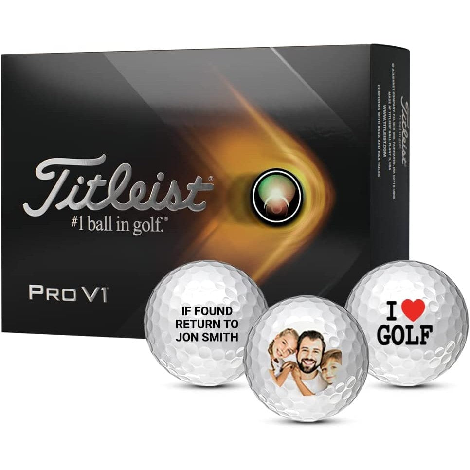 A box of Titleist golf balls with 3 personalized golf balls in front of the box.