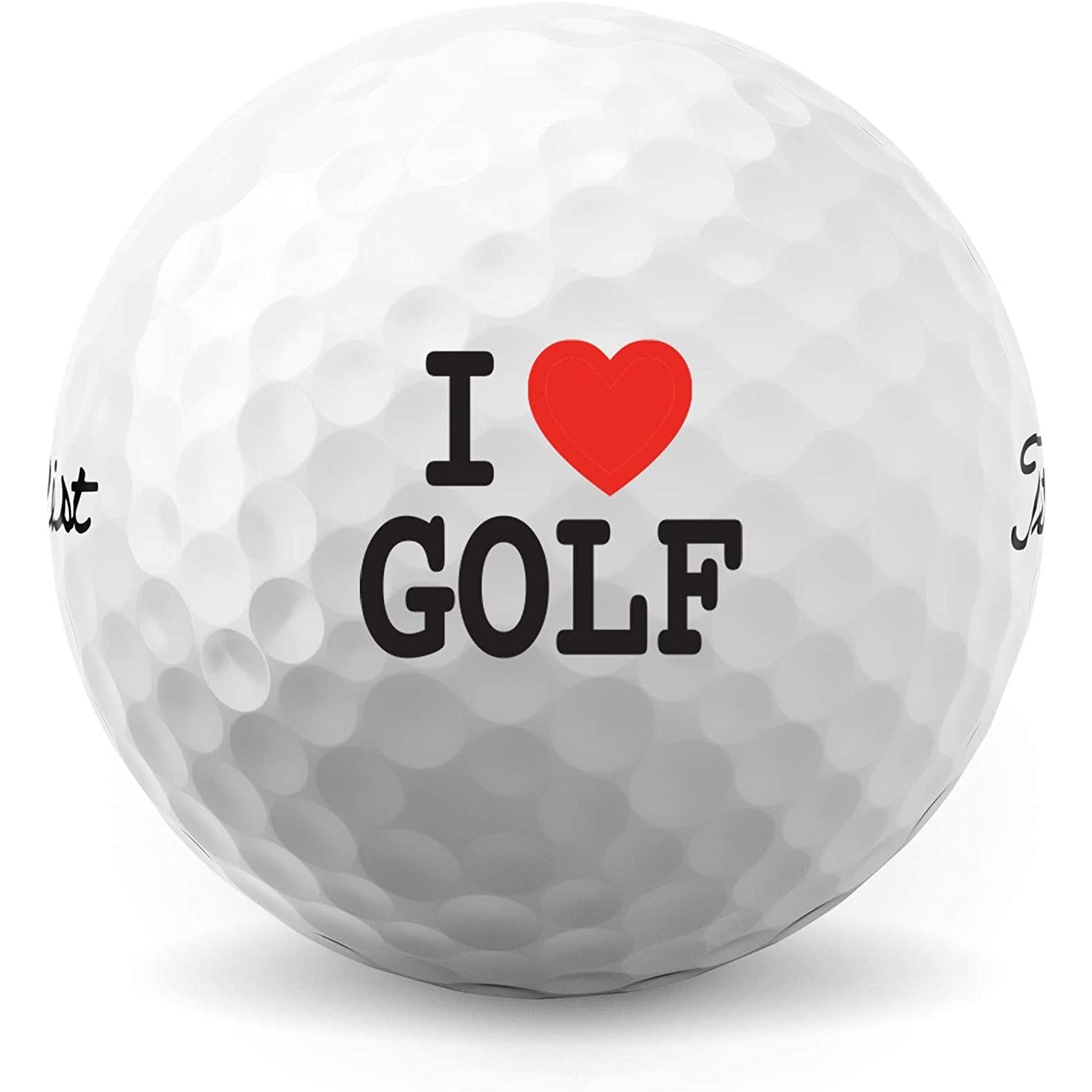 A closeup of a golf ball which has printing on it that says, 'I heart golf.'