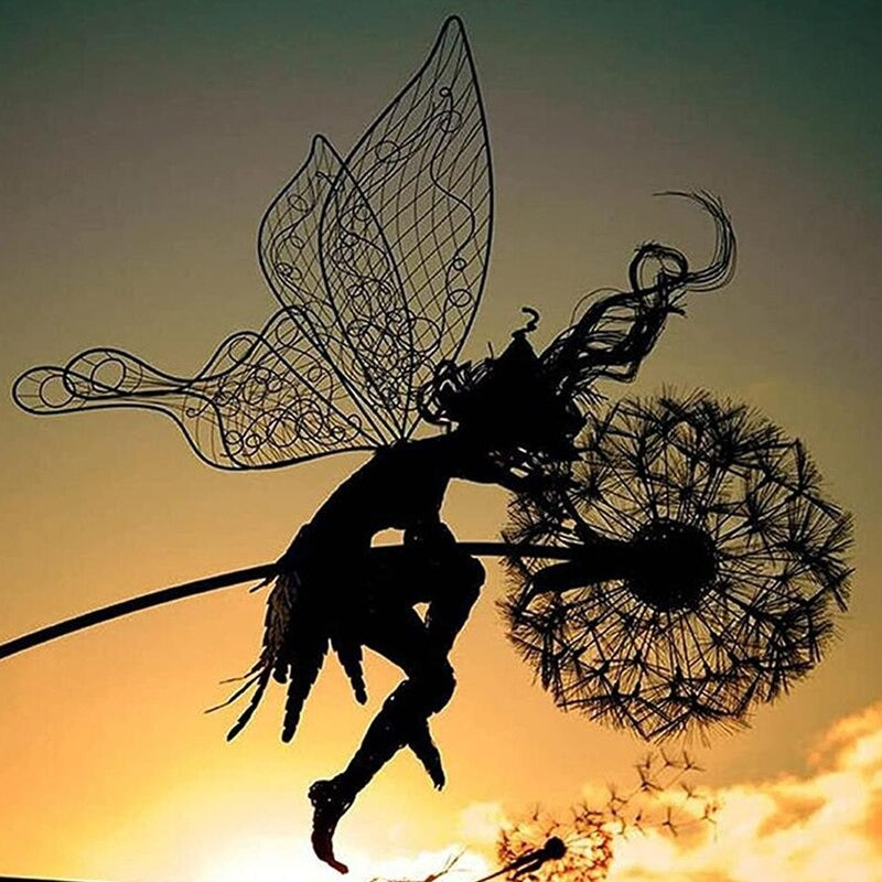 A garden sculpture made of metal. The sculpture is designed to cast a shadow outline as the sun sets in a garden. The sculpture looks like a fairy is holding onto a dandelion as the sun is setting behind her.