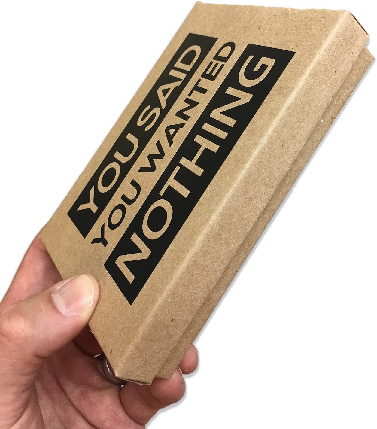 A hand is holding a box which is a gag gift idea for the person who always says they want nothing for an occasion. The lid of the box says, 'You said you wanted nothing.'
