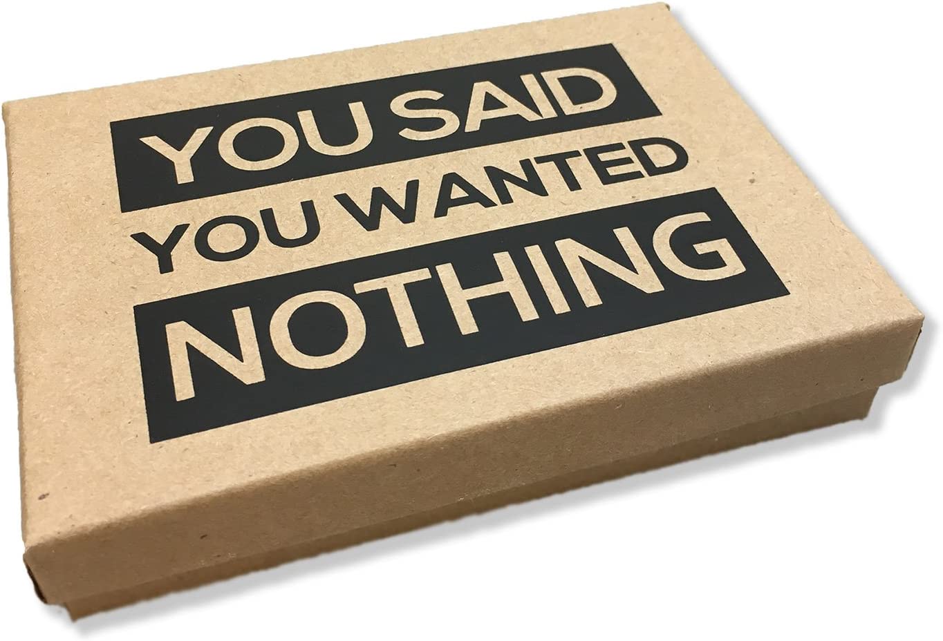 A brown cardboard box which has text on the lid which says, 'You said you wanted nothing.'