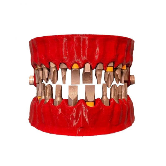 A denture drill bit holder in the shape of a human jaw with drill bits in place of teeth.