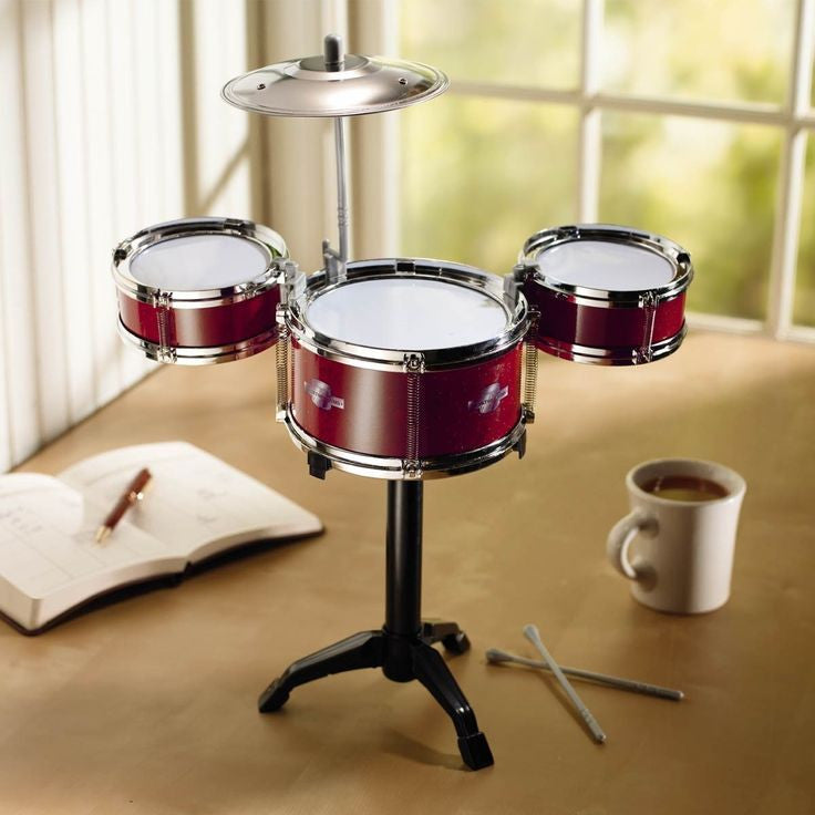Miniature red desktop drum kit with cymbal and drumsticks