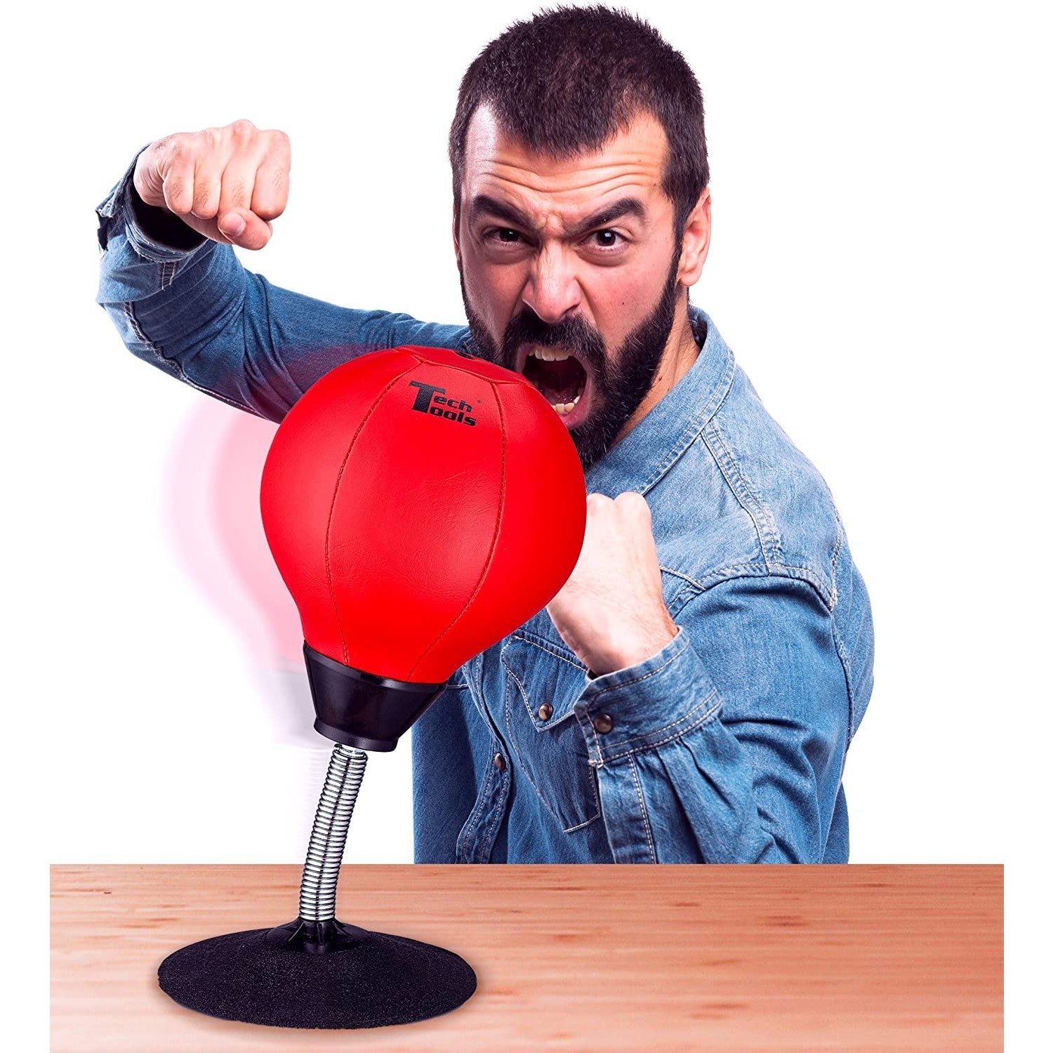 A angry man is about to punch a desktop punching bag.