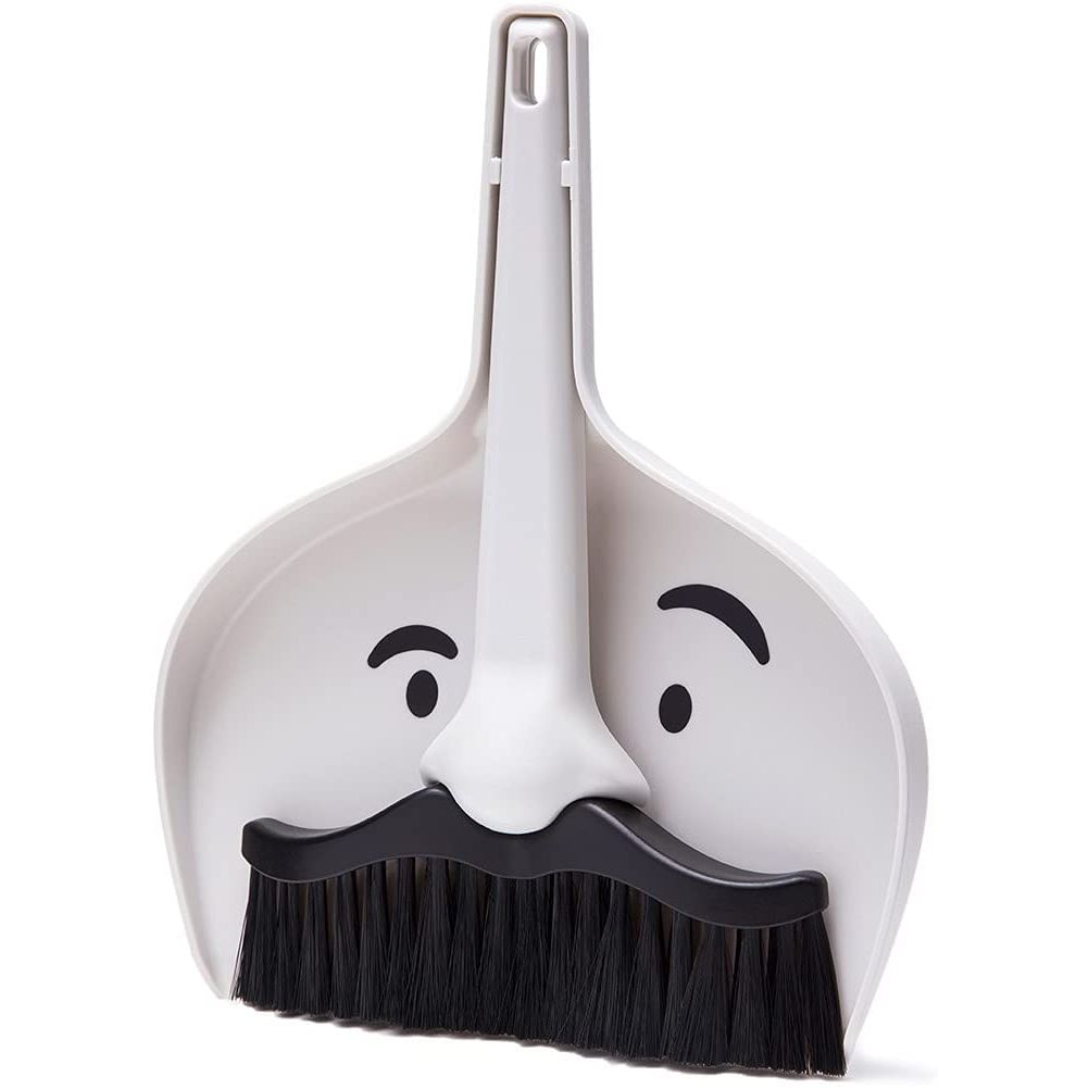 A dustpan and broom set with a face printed on it