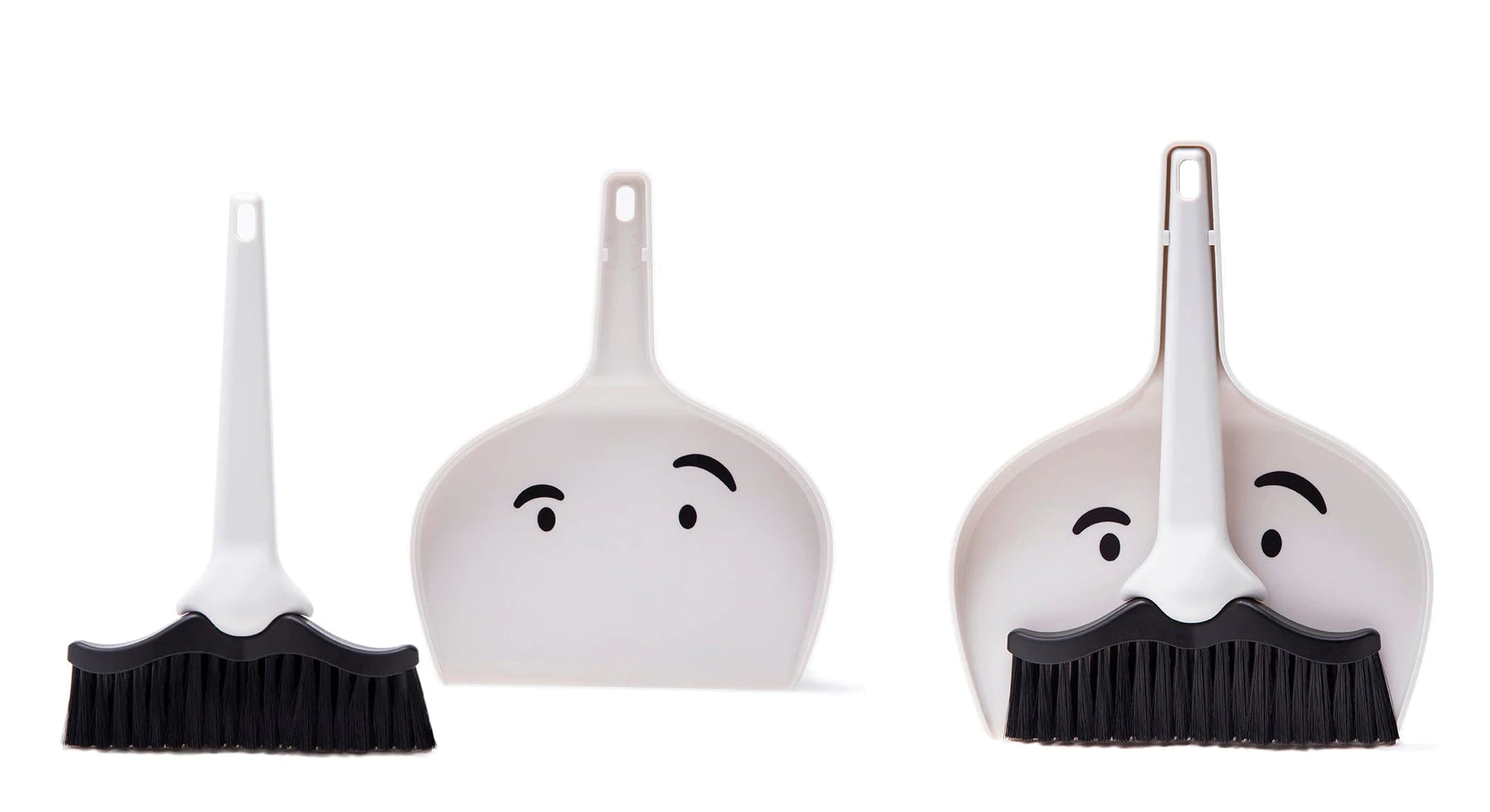 Two dustpan and broom sets both with a face printed on it