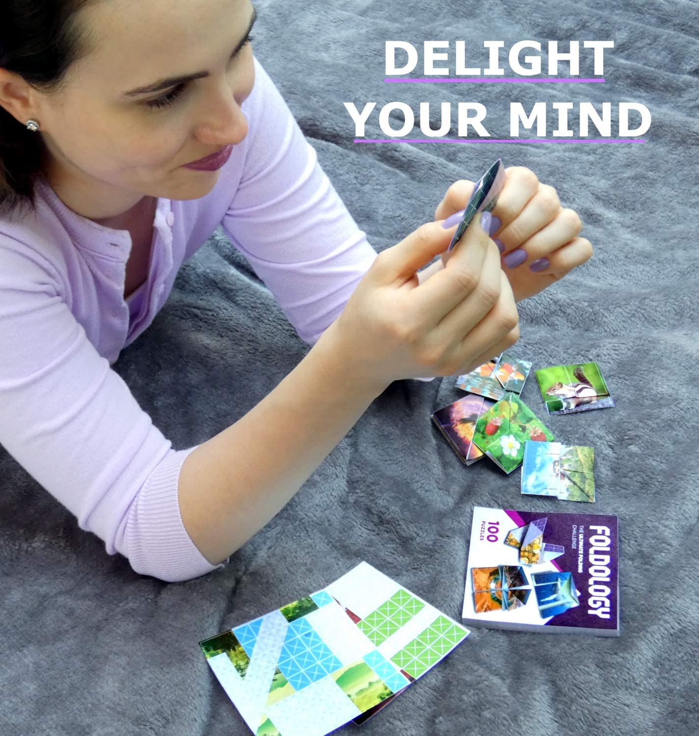 A child is trying to solve a puzzle from the origami puzzle game called Foldology. The is text which says, 'Delight your mind.'