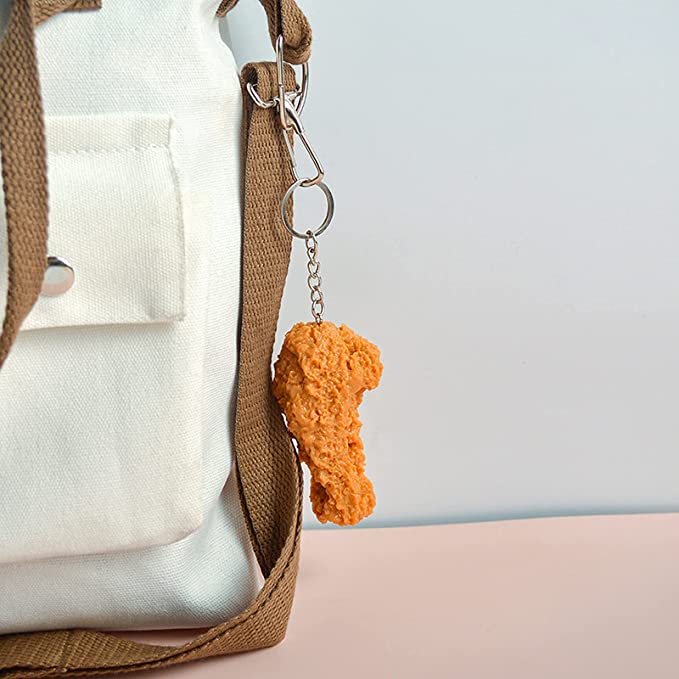 A keychain which looks like a fried chicken drumstick hanging off a bag