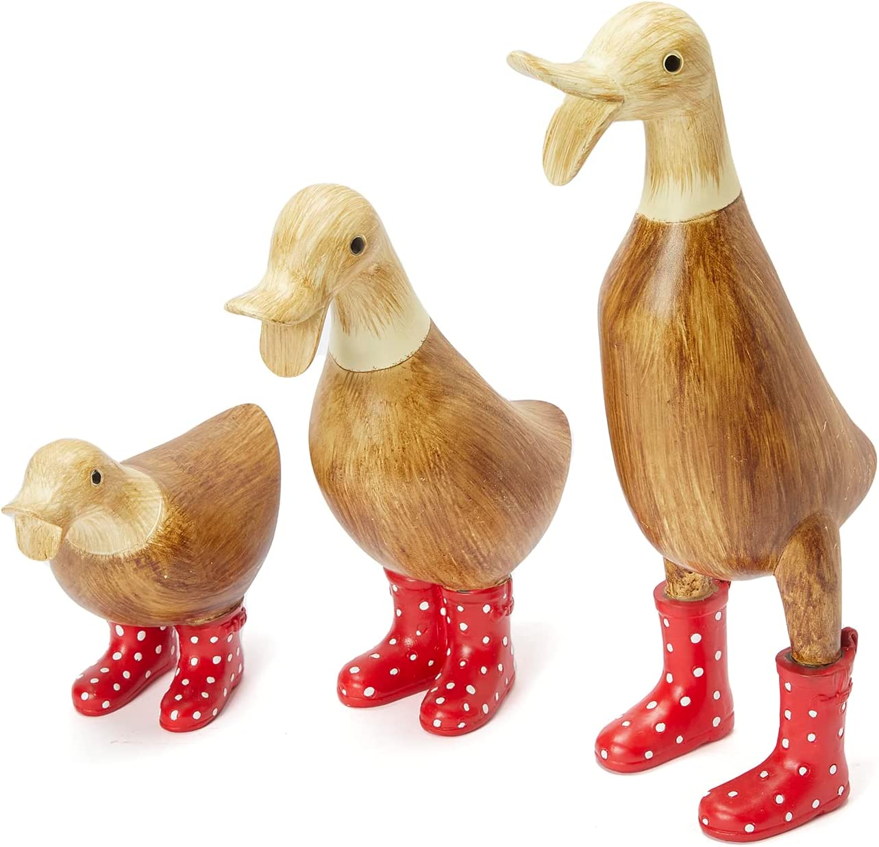 Garden ducks made of wood wearing spotted wellies on a white background.