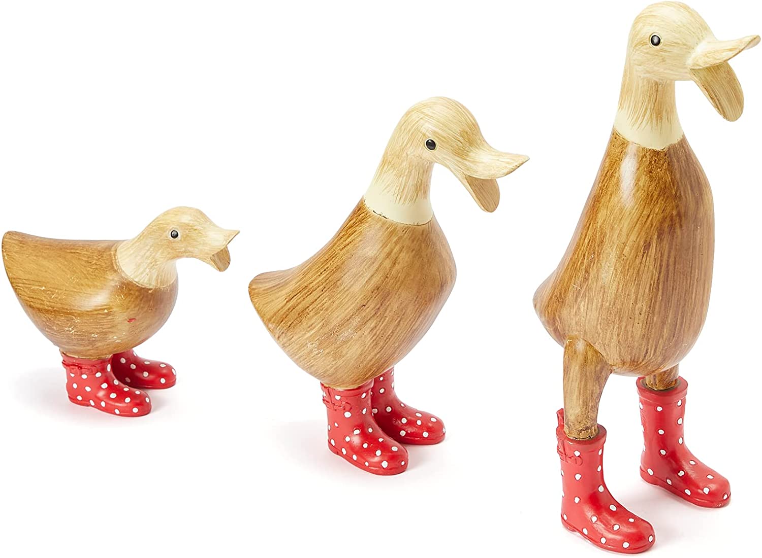Three garden ducks made out of wood. Each duck is in a different pose wearing red spotted wellington boots.