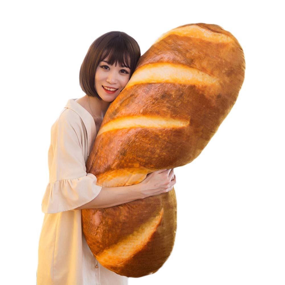 A smiling woman holding a giant pillow that looks like bread