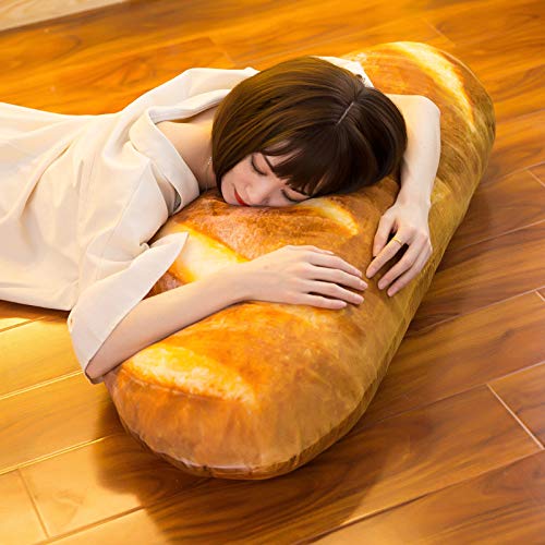 A woman sleeping and resting her head on a giant pillow shaped like bread