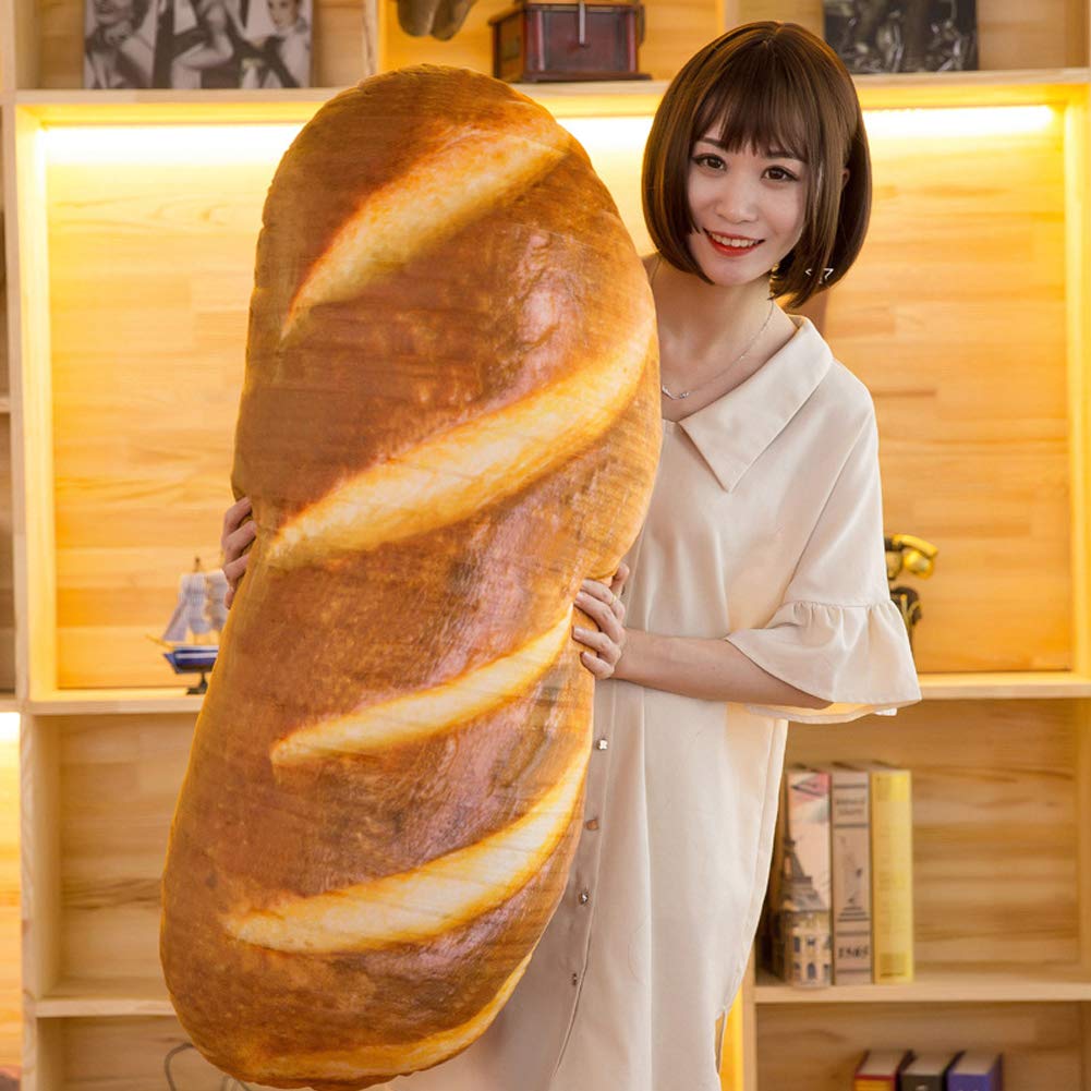 A woman looking at the camera and posing with a giant pillow that looks like bread