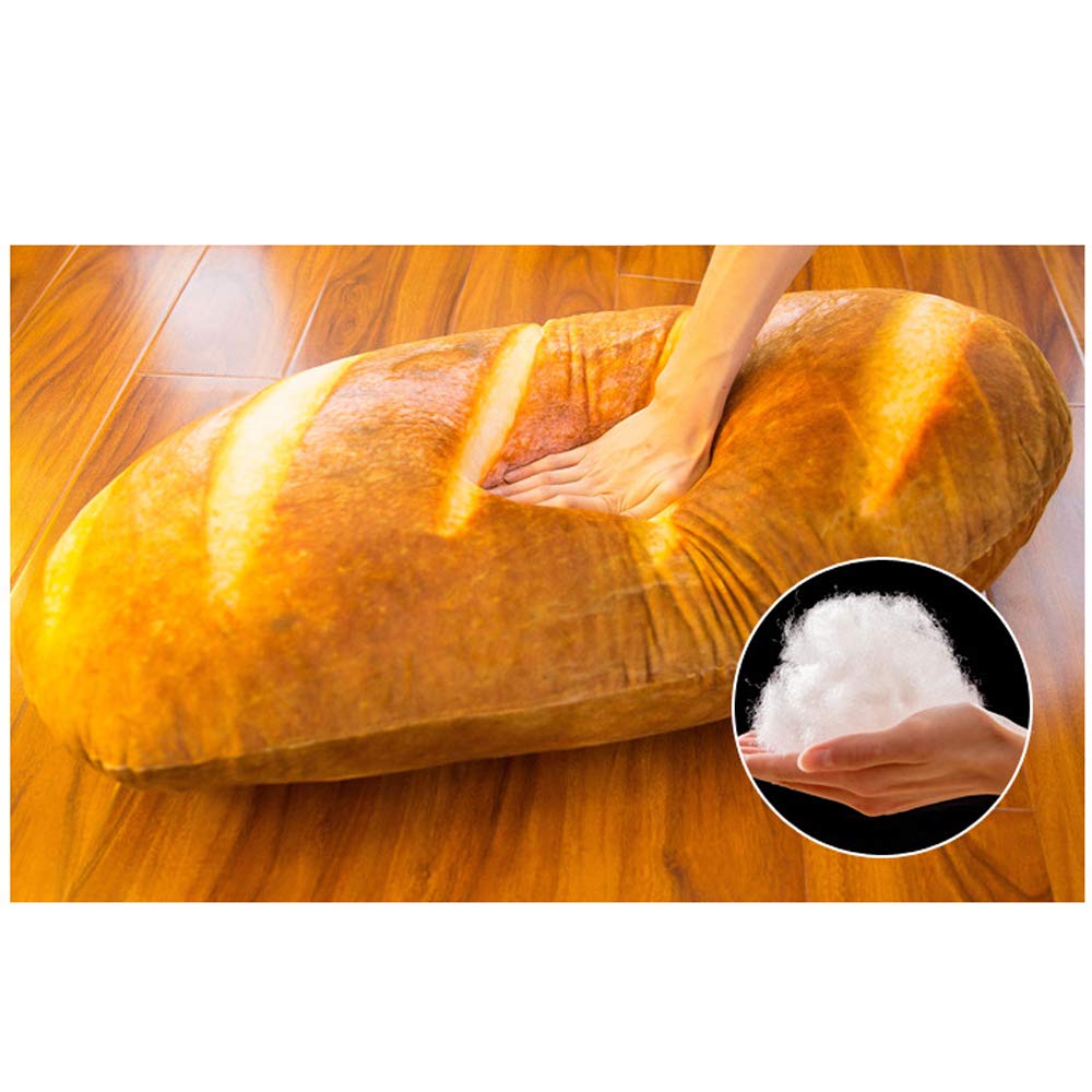 A hand pushing down on a giant bread pillow to show its softness and a smaller inset image of the soft filling inside the pillow
