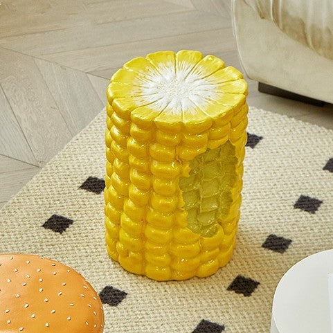 A stool shaped like a giant yellow piece of corn.