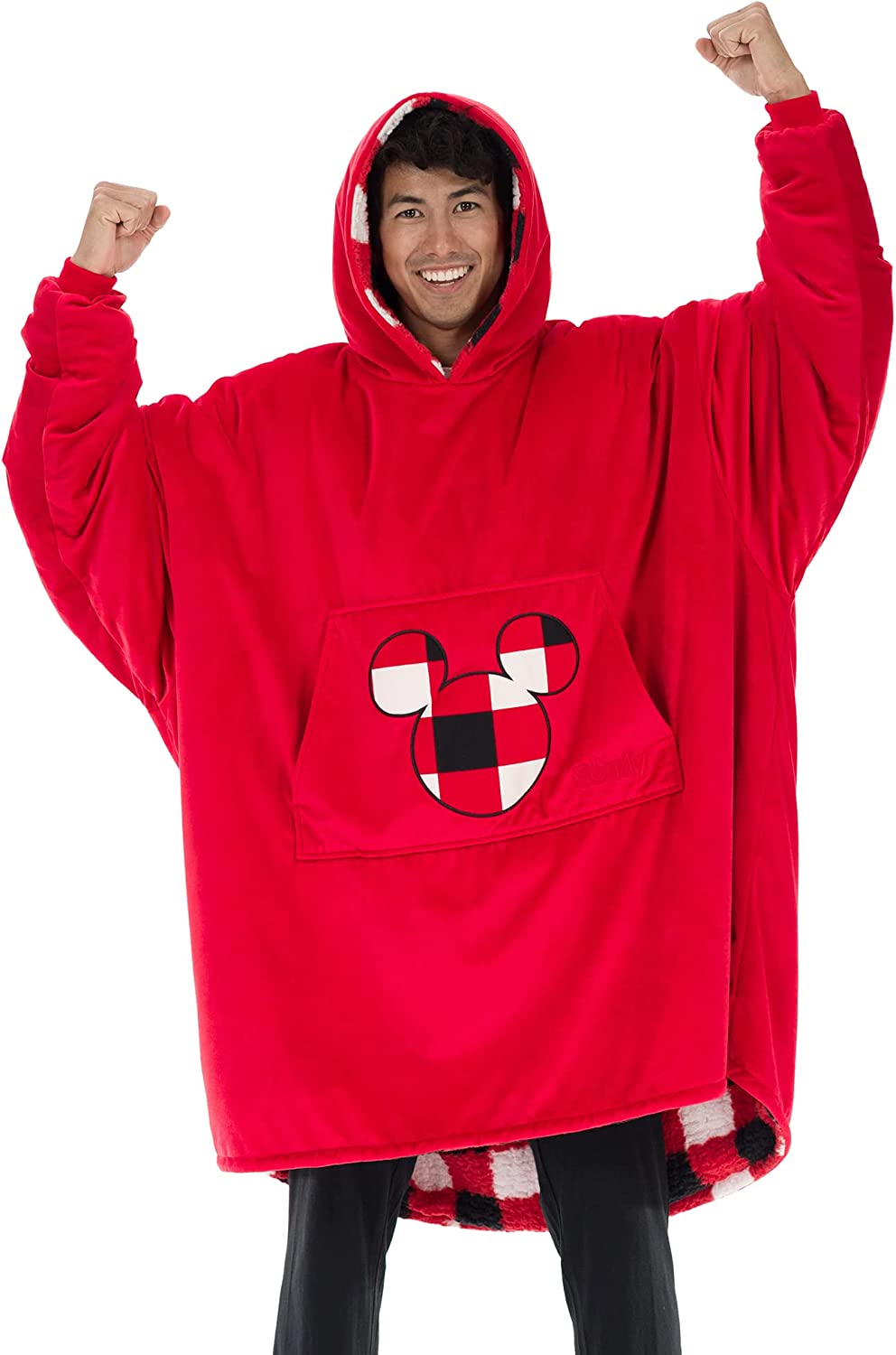A man is smiling while wearing a bright red wearable oversized blanket.