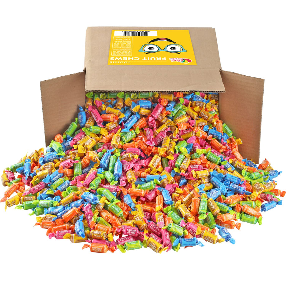 Large cardboard box overflowing with colorful individually wrapped fruit-flavored chewy candies