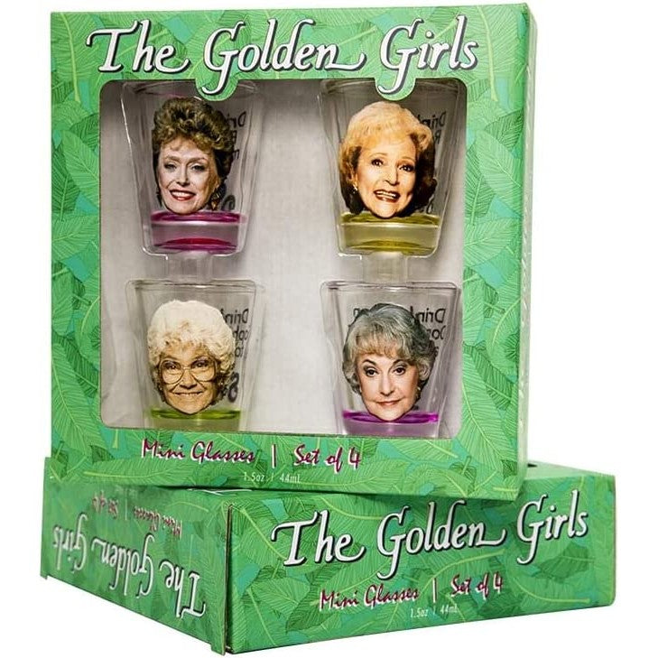 Two boxed sets of Golden Girls shot glasses. One set is laying flat and the other set is facing forward on top.