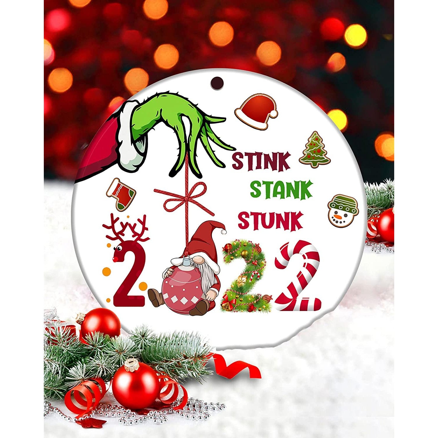 A Christmas tree ornament featuring the Grinch's hand and text which reads, 'Stink, stank, stunk, 2022.'