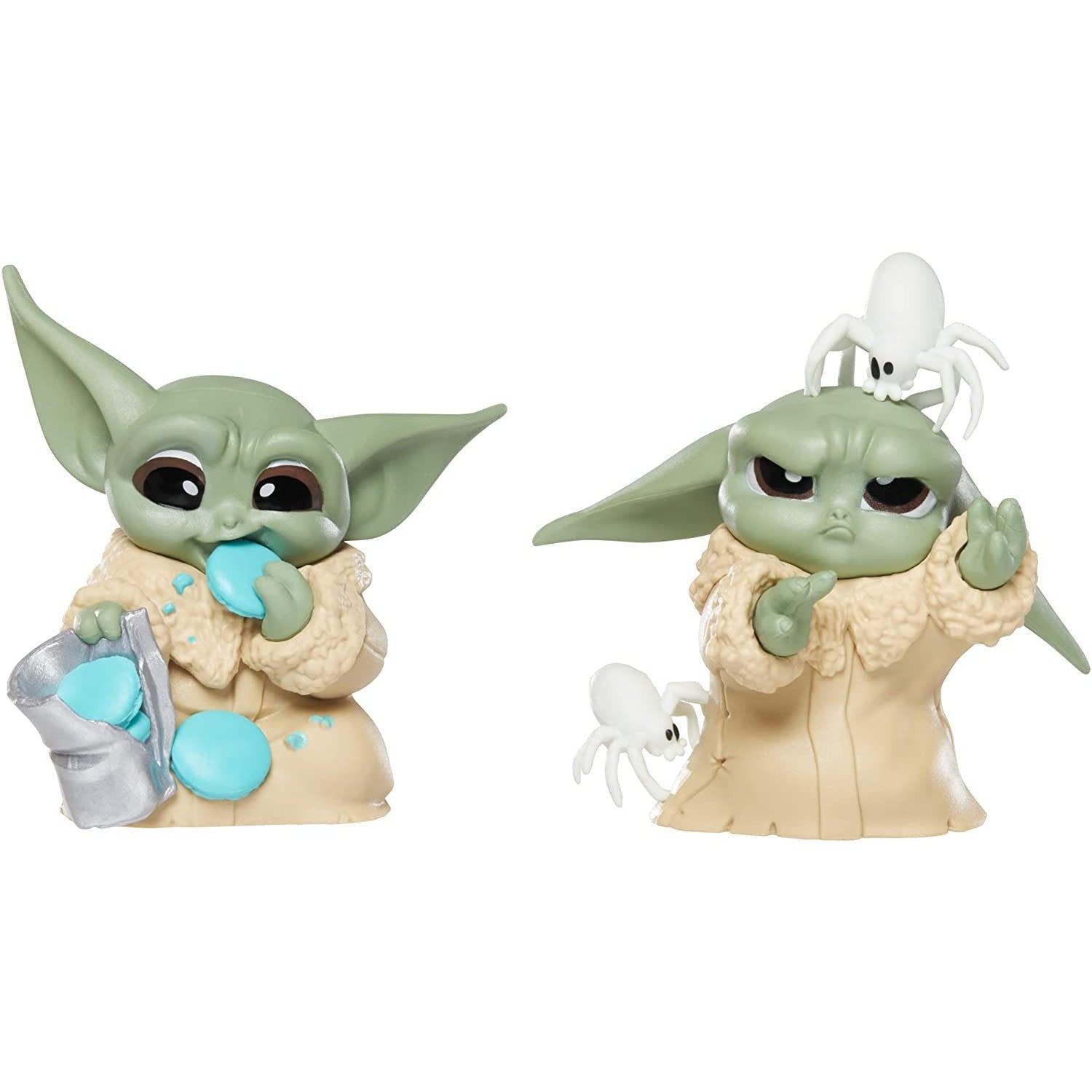 Two figurines of Grogu in “Pesky Spider” and “Cookie Eating” poses.