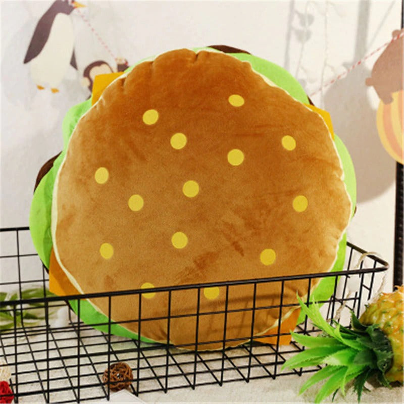 A large plush pillow shaped like a hamburger.