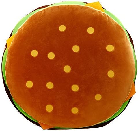 A view from above of a hamburger pillow showing  the top of the sesame bun.