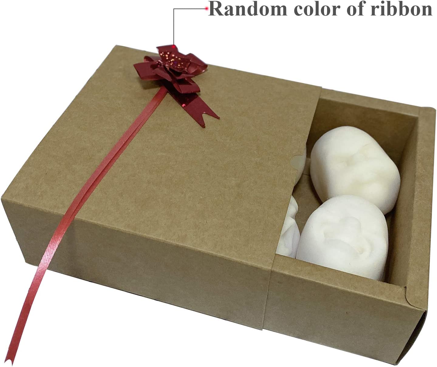 Human face stress balls are packaged up in a gift box. There is a red ribbon on the gift box with the text, 'Random color of ribbon'