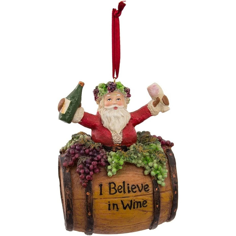 A Christmas tree ornament which features Santa on a wine barrel which reads 'I believe in wine'.
